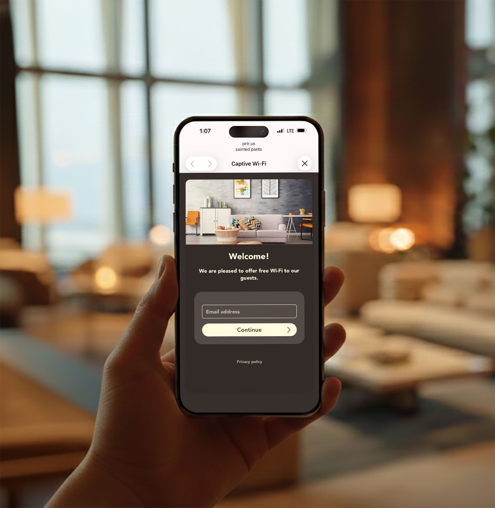 Happy guest holding an iPhone showing a branded Wi-Fi splash page